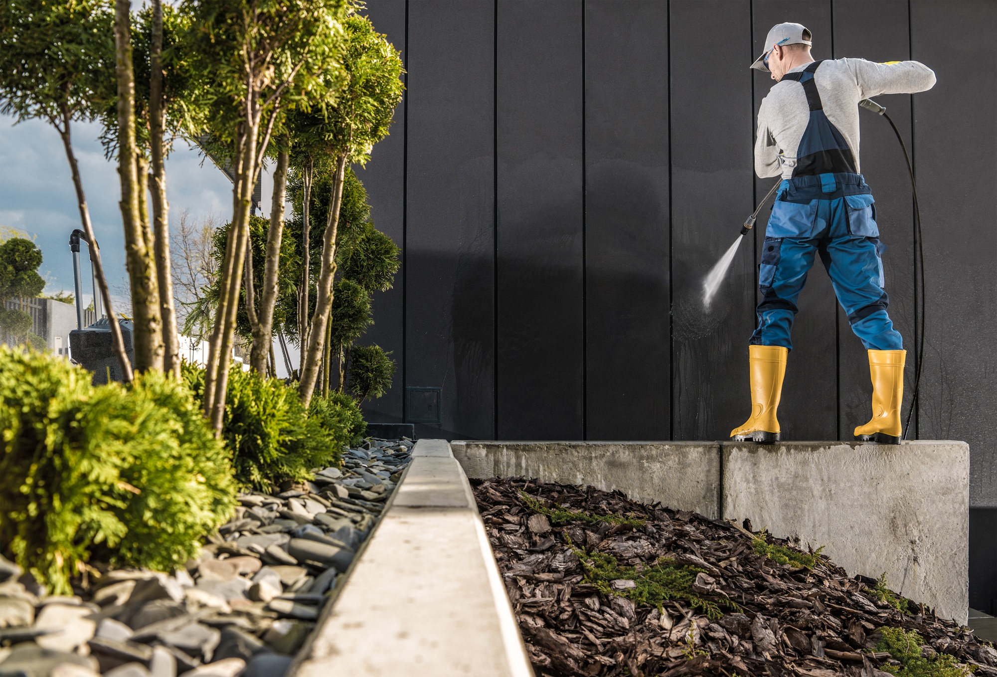 Professional Worker Pressure Washing House Walls